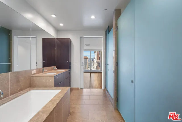 a bathroom with a tub shower and sink