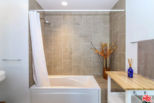 a bathroom with a tub and shower