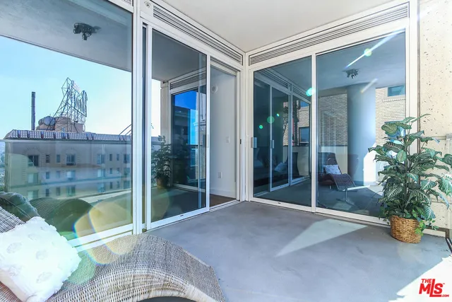 a bedroom with a bed and a potted plant