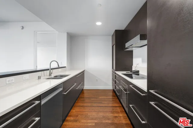 a large kitchen with kitchen island a sink stove and refrigerator