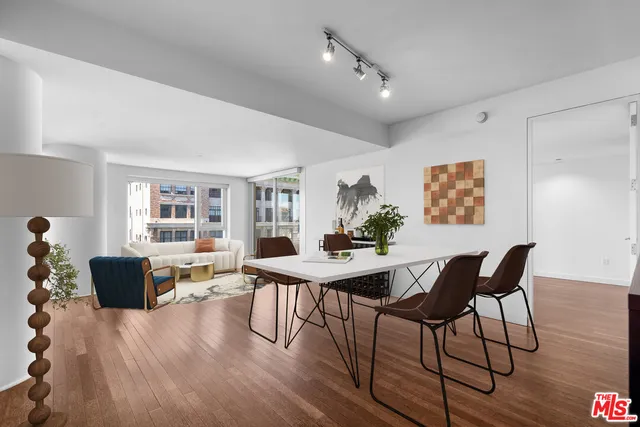 a view of a dining room with furniture window and wooden floor