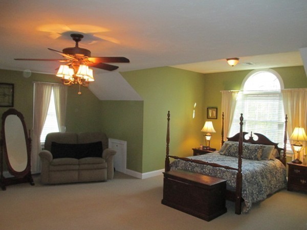 23 Spring Street Rehoboth, MA 02769 - Photo 19 of 27 a bedroom with a bed and chandelier