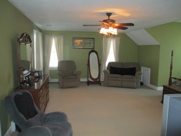 23 Spring Street Rehoboth, MA 02769 - Photo 20 of 27 a living room with furniture a chandelier a fireplace and a chandelier