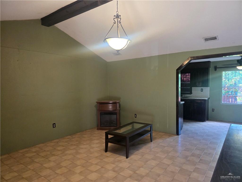 519 East 3rd Street Sullivan City, TX 78595 - Photo 4 of 12 Living room with arched walkways and a fireplace