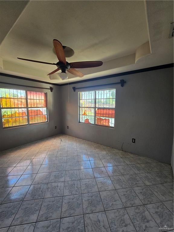 519 East 3rd Street Sullivan City, TX 78595 - Photo 8 of 12 Unfurnished room featuring light tile patterned floors and a ceiling fan