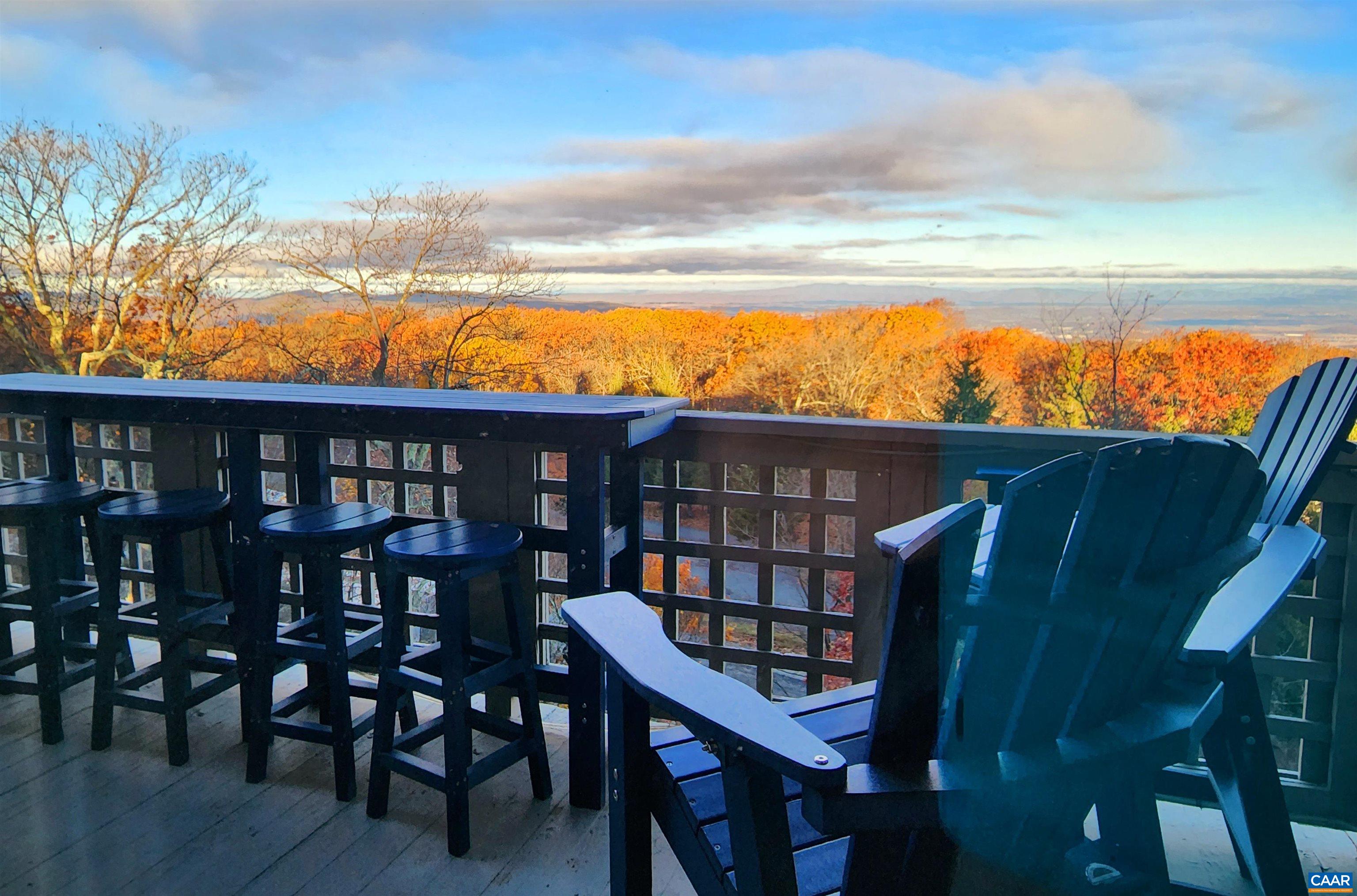 a view of a chairs and table on the deck