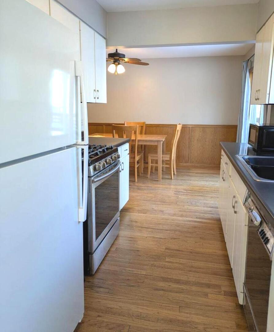 21W230 Pershing Avenue Lombard, IL 60148 - Photo 9 of 41 a kitchen with granite countertop a stove and a refrigerator