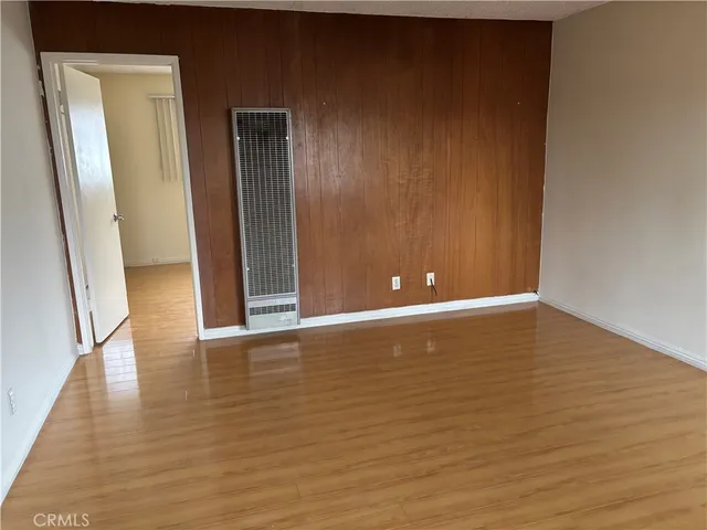 a view of room with window and wooden floor