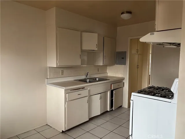 a kitchen with a stove and a refrigerator