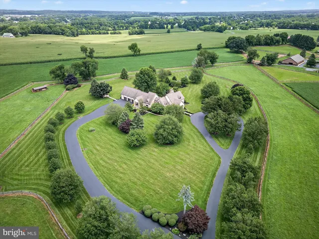 an aerial view of a house with a yard