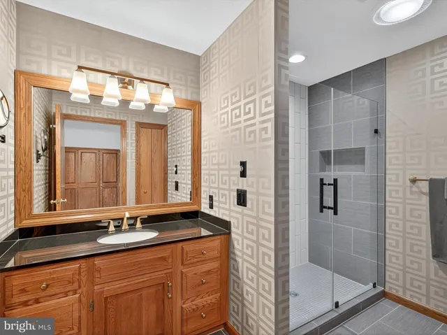 a view of a big house with a big yard and large trees