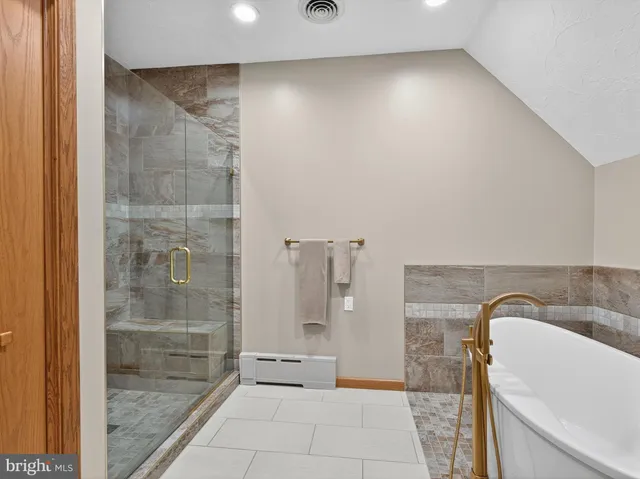 an aerial view of a house with a garden and lake view