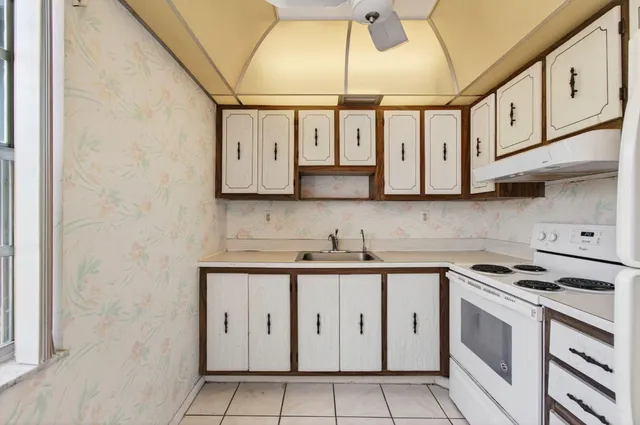 a view of a room with wooden floor and white walls