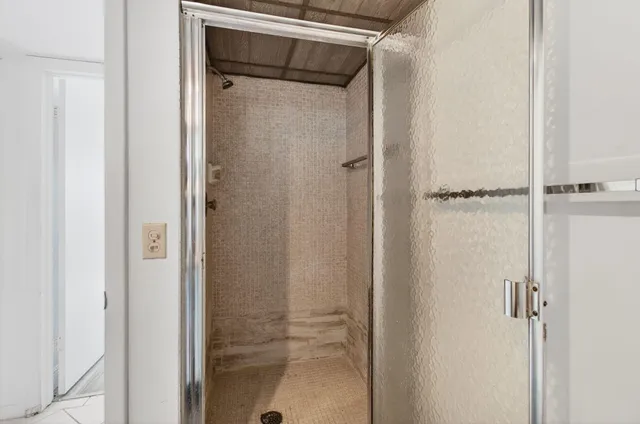 a bathroom with a sink toilet vanity and shower