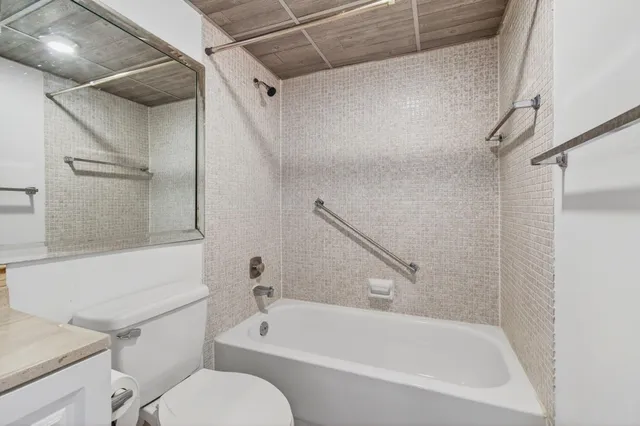 a view of a room with wooden floor and ceiling fan