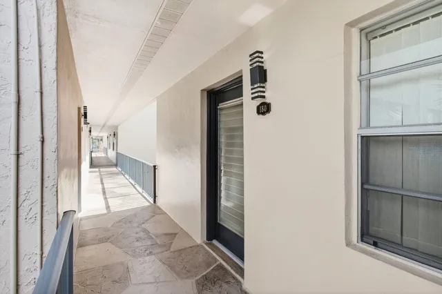 a view of a hallway with windows and entryway