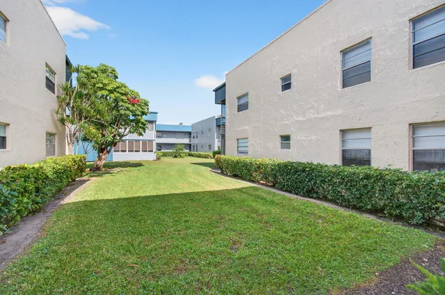 a view of a house with a yard and garden