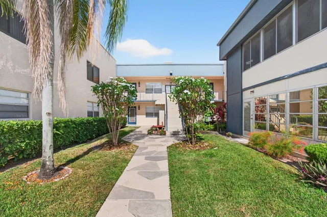 a view of a swimming pool with a patio and a yard