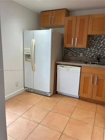 a kitchen with cabinets and stainless steel appliances
