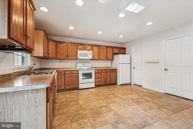 a kitchen with stainless steel appliances granite countertop a stove sink and cabinets