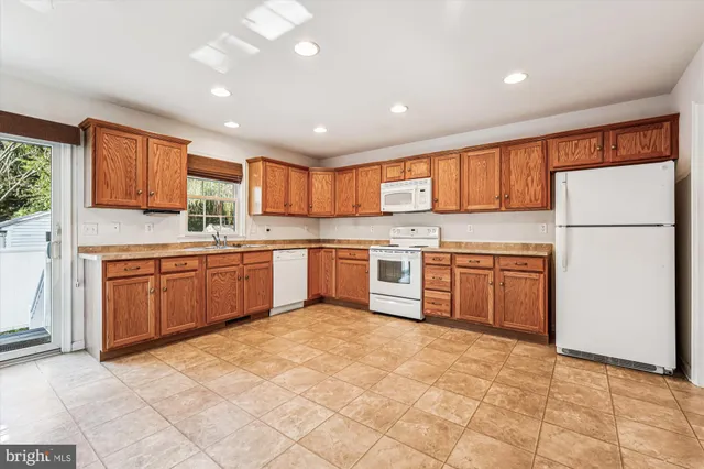 a kitchen with a stove sink and white refrigerator