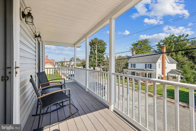a view of a two chairs in the balcony