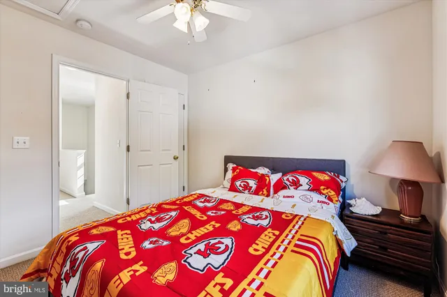 a bedroom with a bed and a lamp