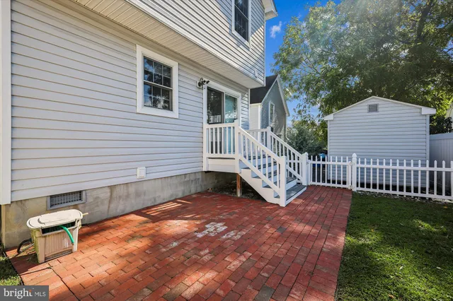a view of a backyard with a deck and a garden