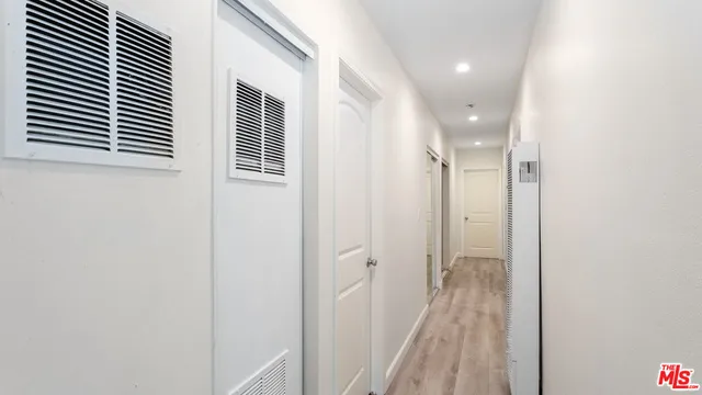a view of a hallway with a white walls