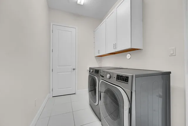 a view of a patio with a table and chairs under an umbrella