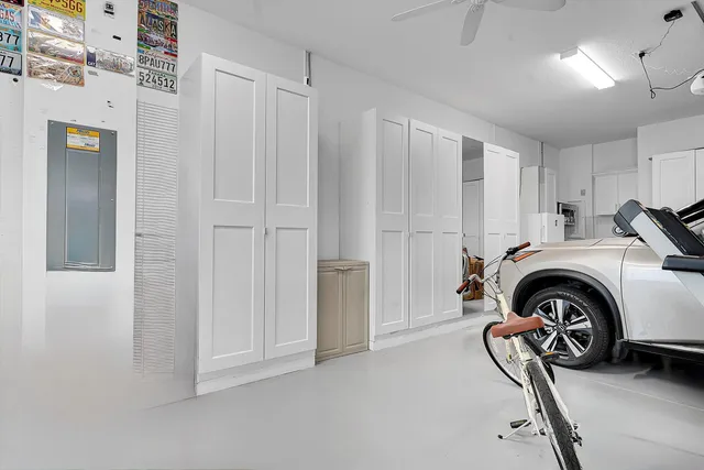 a view of a roof deck with table and chairs under an umbrella