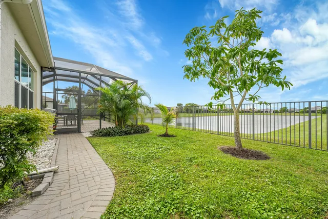 a aerial view of a house with a yard and lake view