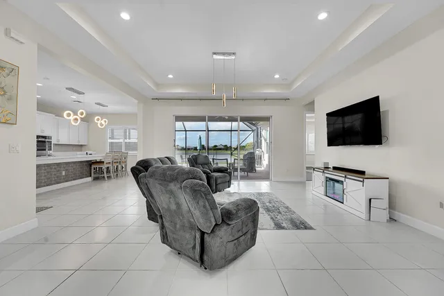 a living room with furniture and a chandelier