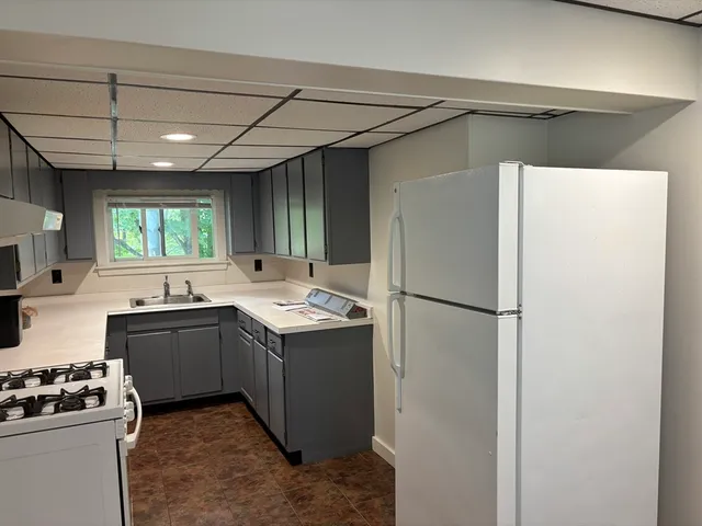 a kitchen with a sink and a refrigerator
