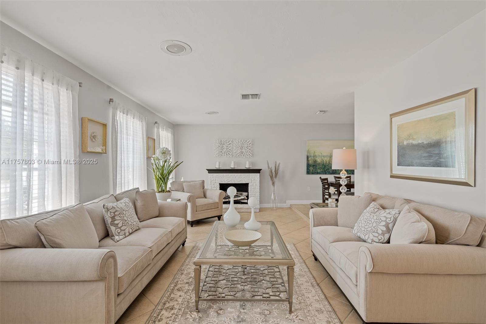 6311 Southwest 93rd Court Miami, FL 33173 - Photo 1 of 41 a living room with furniture a rug and a fireplace