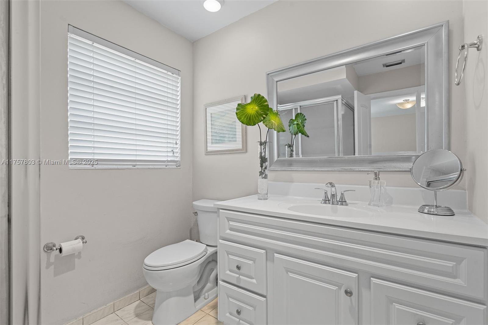 6311 Southwest 93rd Court Miami, FL 33173 - Photo 24 of 41 a bathroom with a toilet sink and mirror