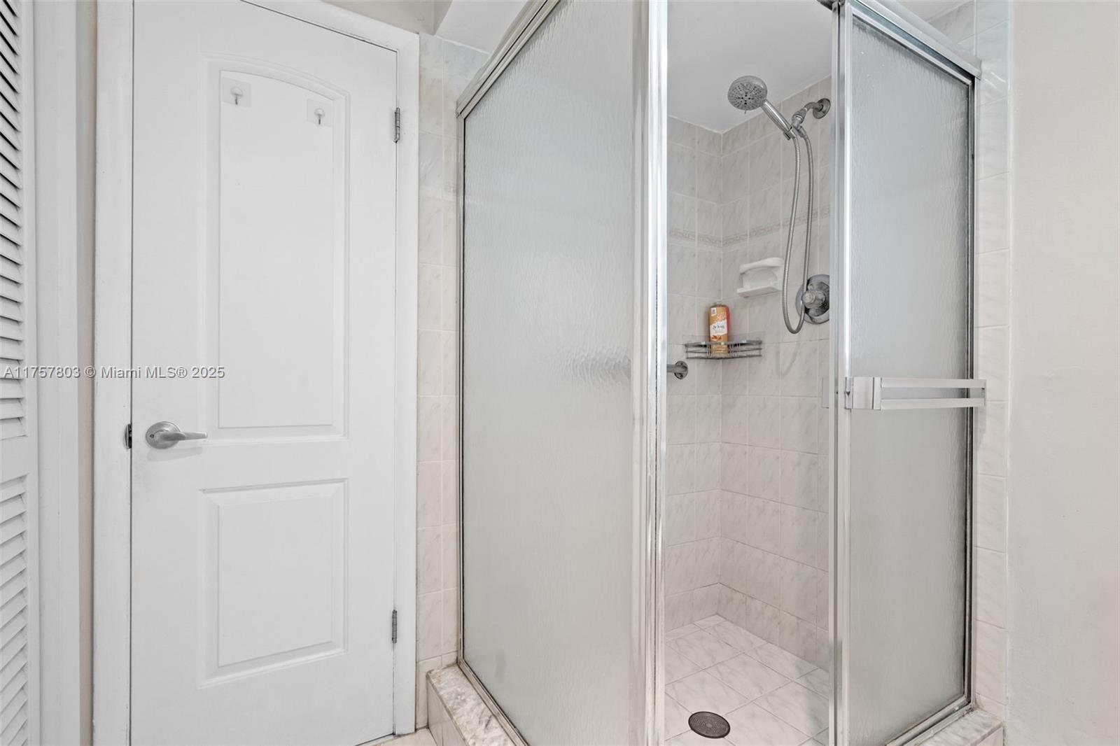 6311 Southwest 93rd Court Miami, FL 33173 - Photo 25 of 41 a bathroom with a glass shower door