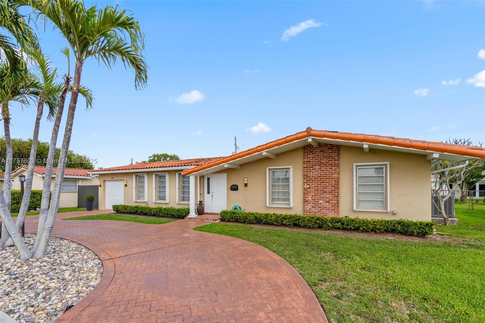 6311 Southwest 93rd Court Miami, FL 33173 - Photo 40 of 41 a front view of a house with a yard and potted plants