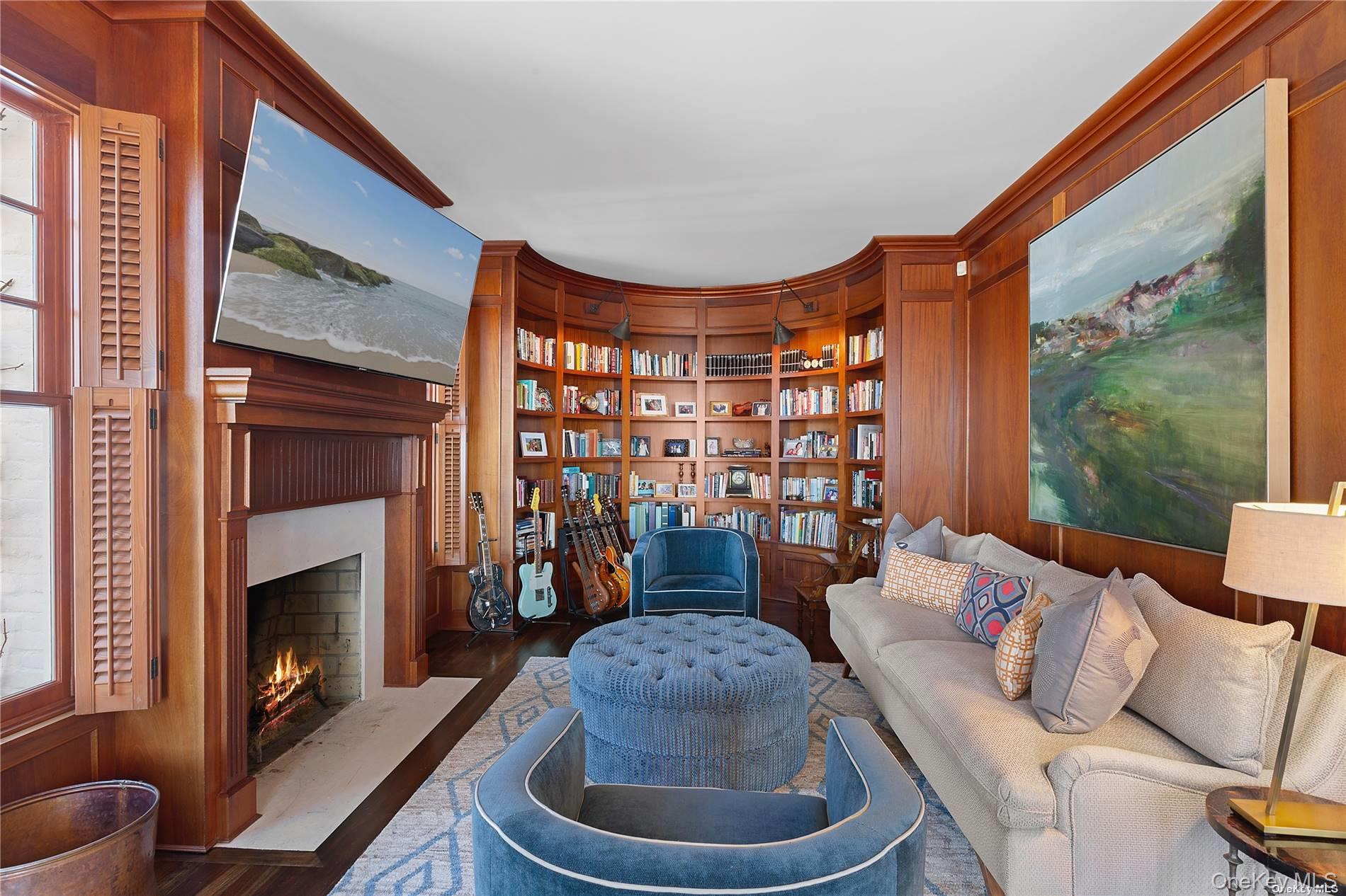 74 Cedar Lane West Remsenburg, NY 11960 - Photo 13 of 37 a living room with furniture a fireplace and a floor to ceiling window
