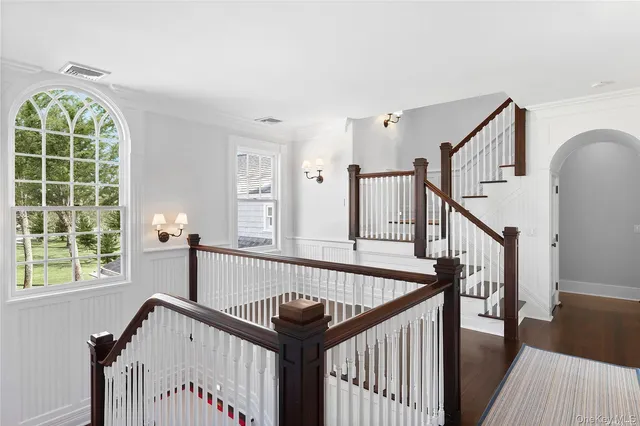 a view of entryway with a window and wooden floor