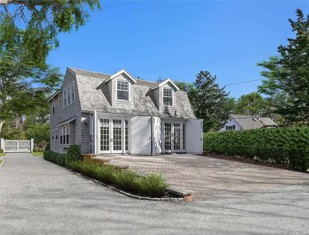 a front view of a house with a garden