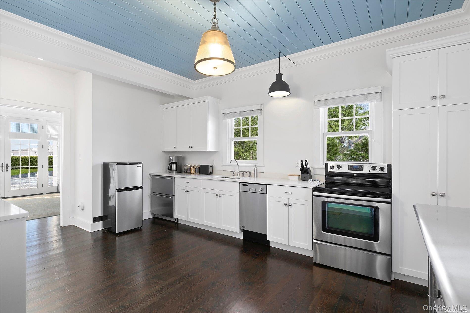 74 Cedar Lane West Remsenburg, NY 11960 - Photo 27 of 37 a kitchen with stainless steel appliances a stove a sink and a refrigerator