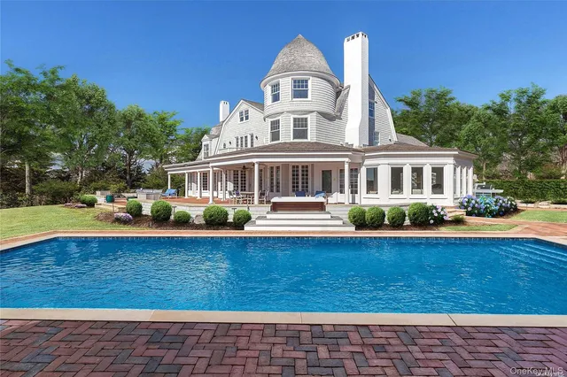 a front view of a house with yard and green space