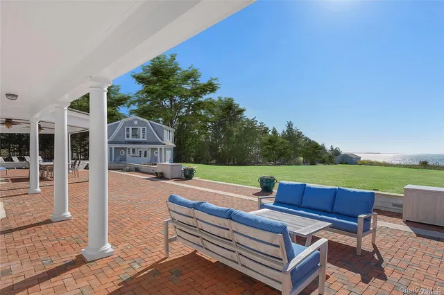 a view of patio with lawn chairs wooden floor and fence