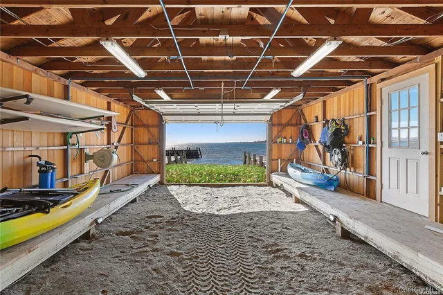 a view of a garage with wooden deck