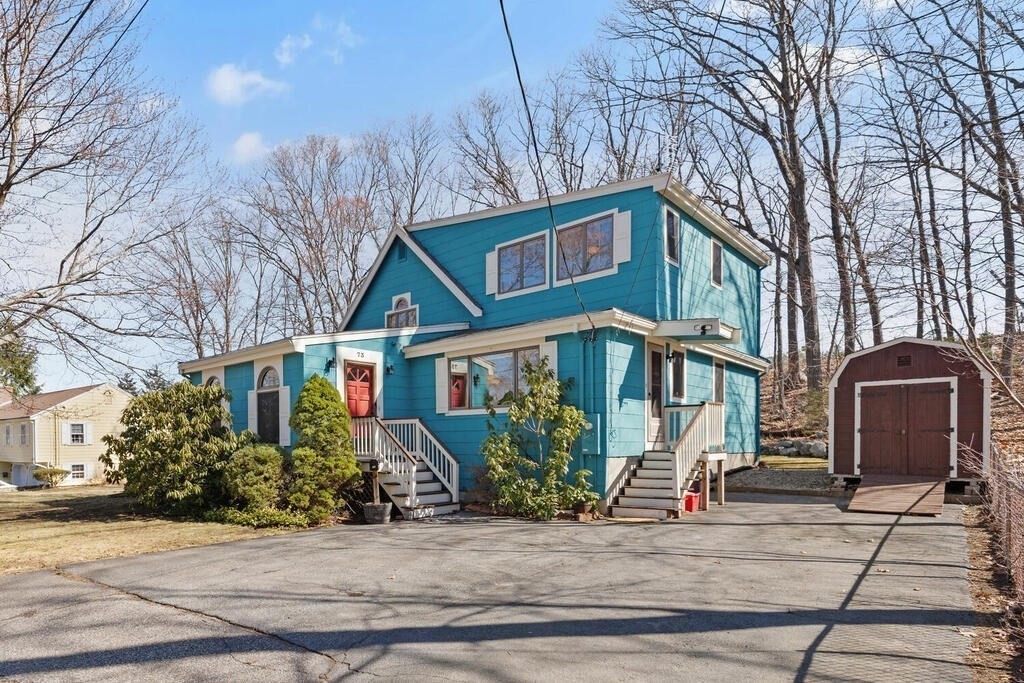 73 Longfellow Road Reading, MA 01867 - Photo 1 of 32 a front view of a house with garden
