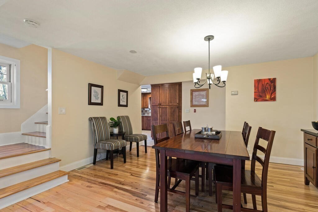 73 Longfellow Road Reading, MA 01867 - Photo 11 of 32 a dining room with furniture a chandelier and wooden floor