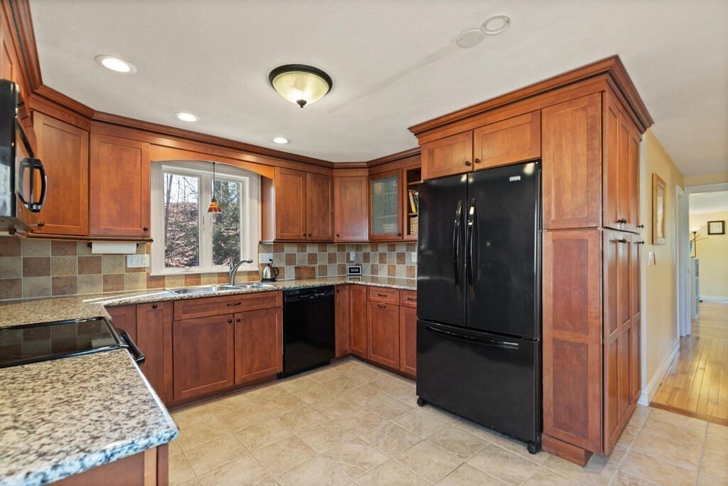 73 Longfellow Road Reading, MA 01867 - Photo 13 of 32 a kitchen with granite countertop stainless steel appliances a refrigerator cabinets and a sink