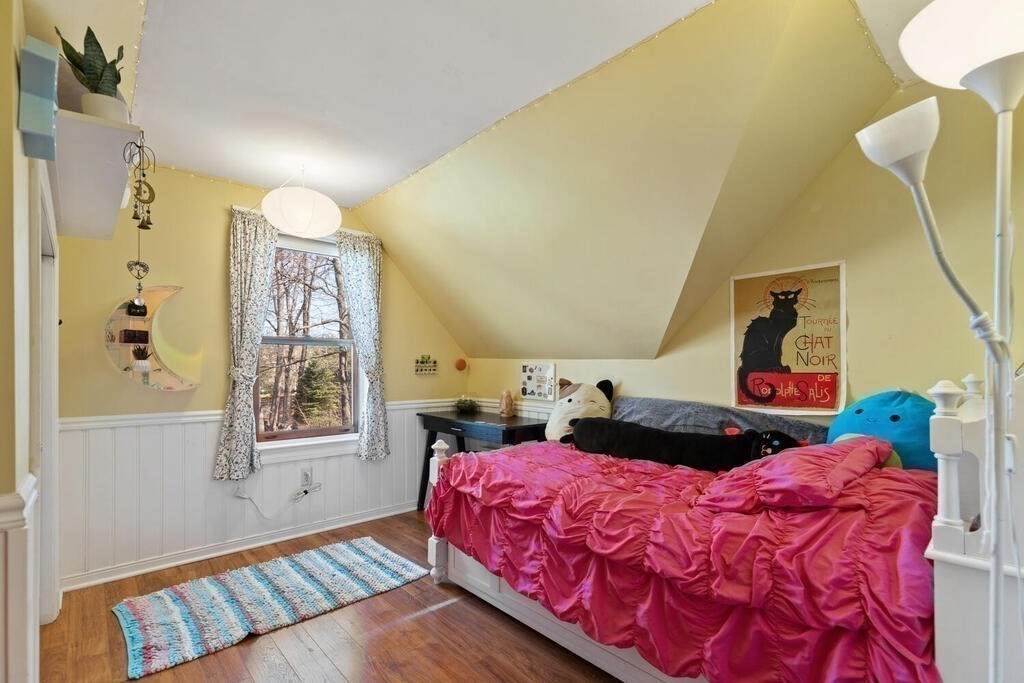 73 Longfellow Road Reading, MA 01867 - Photo 19 of 32 a bedroom with a bed and a chandelier