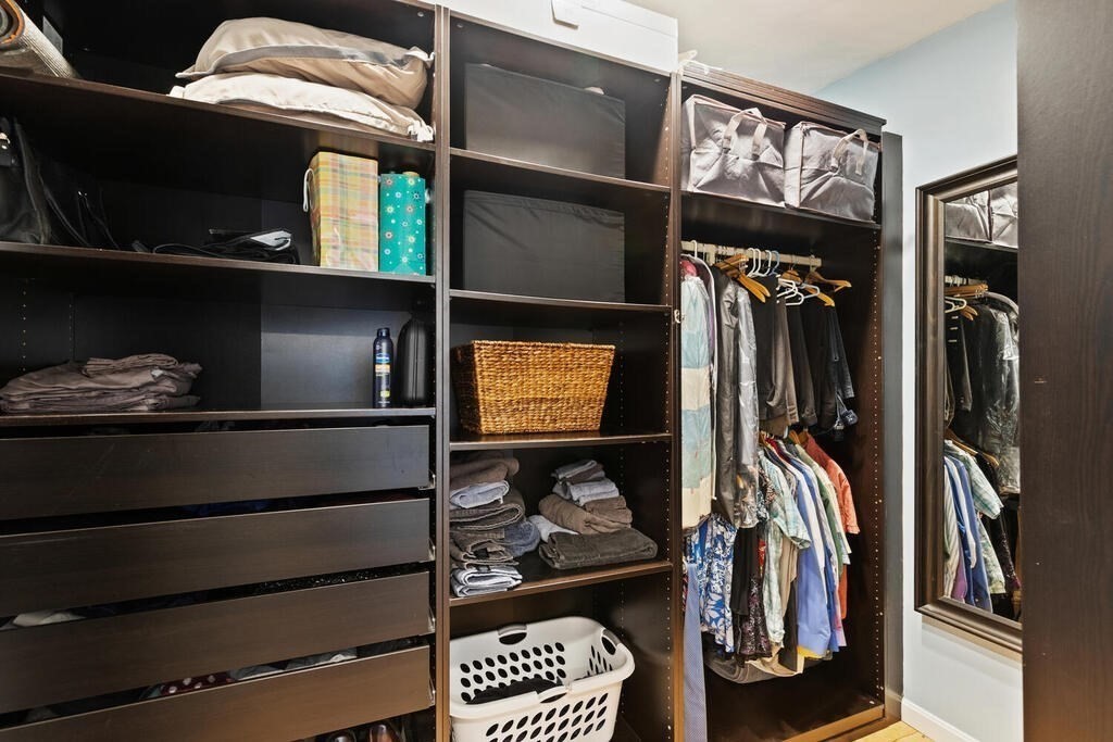 73 Longfellow Road Reading, MA 01867 - Photo 26 of 32 a view of walk in closet with clothes and shoes
